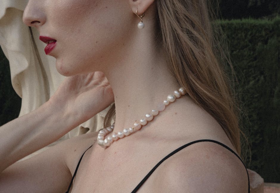 An image of a person holding a pearl necklace, representing the spiritual interpretations of pearls in the contemporary era.